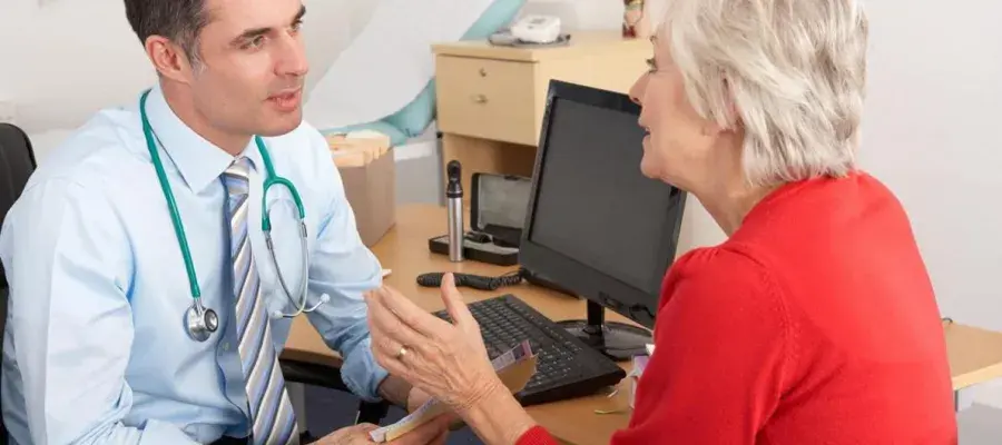 Dr speaking with patient in consultation room