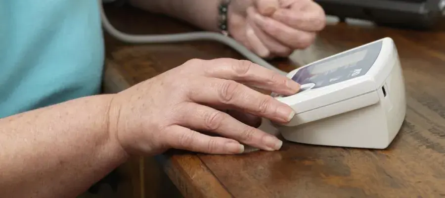 Patient using a blood pressure monitor